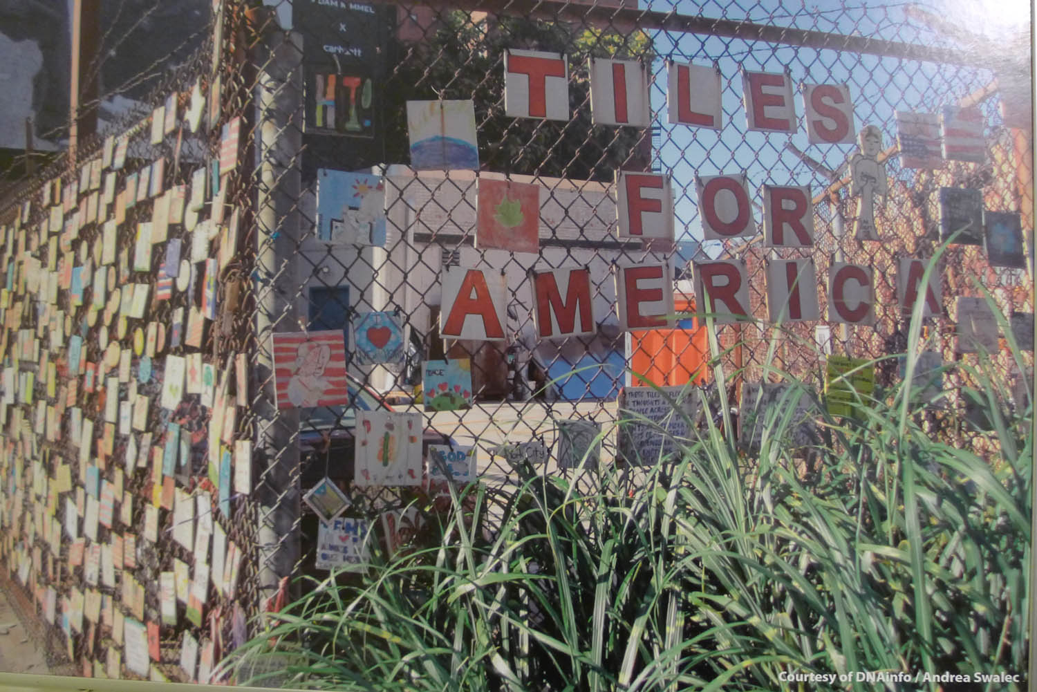 Tiles for America hanging on a fence in the West Village before they were removed